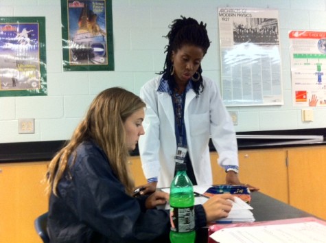 Senior MaryEllen Hawkland receives instruction from Ms. Walker during her Physics class. Ms. Walker structures her groups based on gender, believing that throwing a girl in the mix of a group of males can make it hard for the female student to get her point across. 