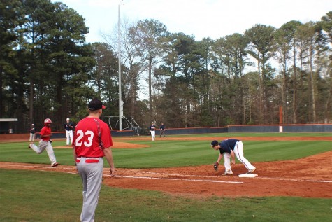 The batter from Osborne High School gets thrown out at first base by junior Shane Wiltsey.