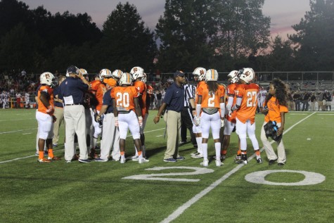 Coach Tener, Coach Carter, and Coach Rainey discuss the game plan during a time-out to the North Cobb defense.