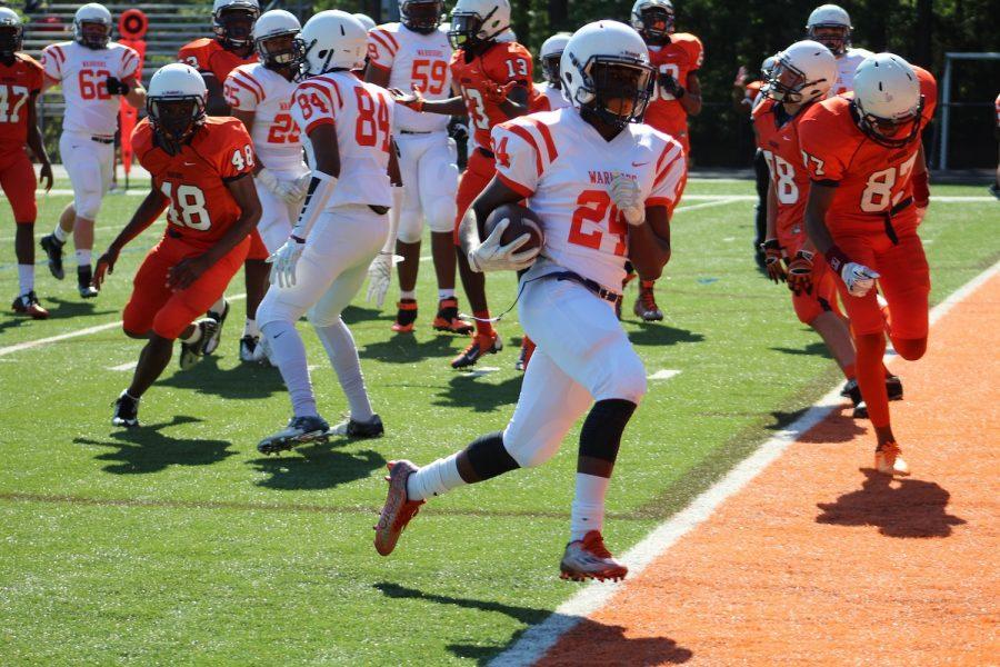 Sophomore defensive back Elisha Linley scoring a touchdown for the white team. Linley, among others, helped the white team secure their win, defeating the orange team by six points.  