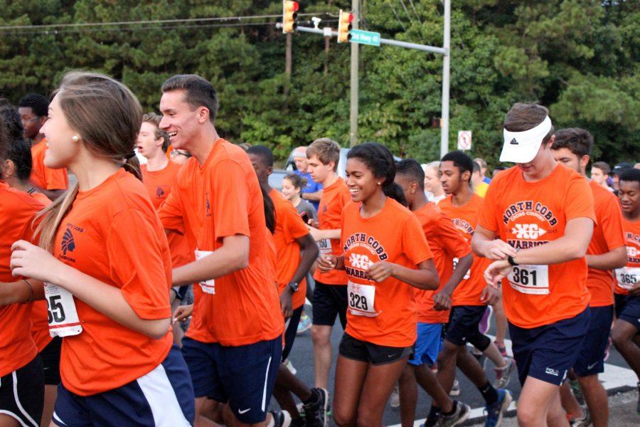 Orange shirts cover Blue Springs Road as the Warrior Nation and community starts the race.