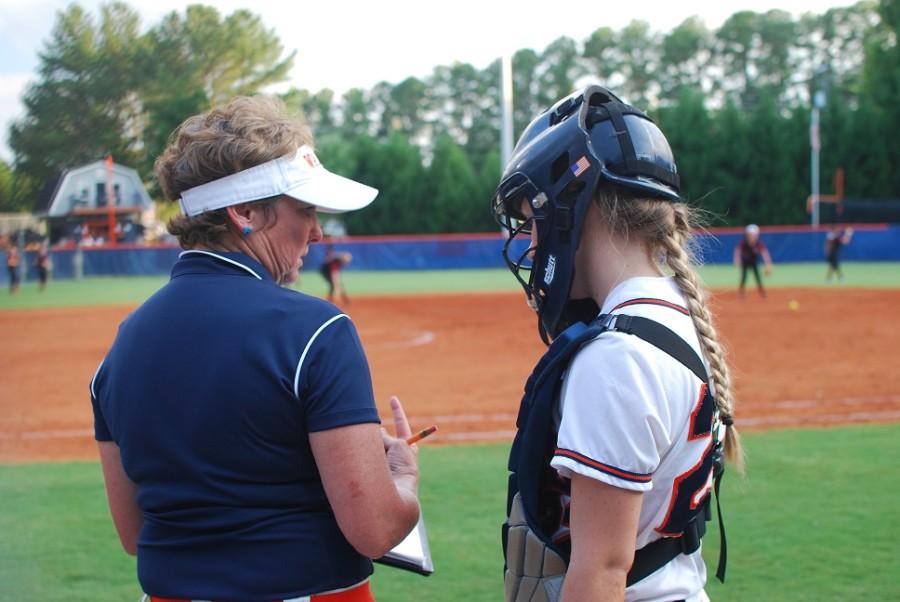 Weaver advises senior catcher, Kayla Trumbull with wisdom to win the game.