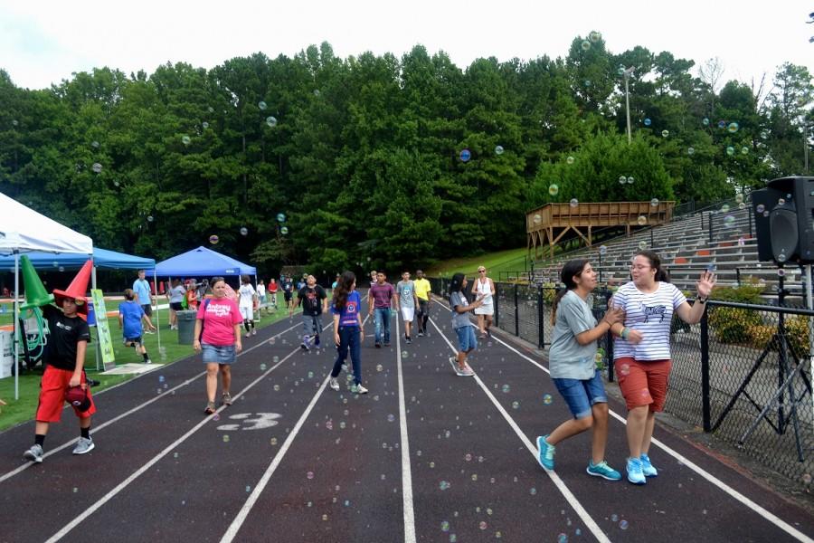 Awtrey middle schoolers walk the track while being engaged with activities that combine fun with exercise.