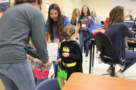 Junior Ashley Hunter accompanies Batman while he stocks up on candy before saving the world tonight.