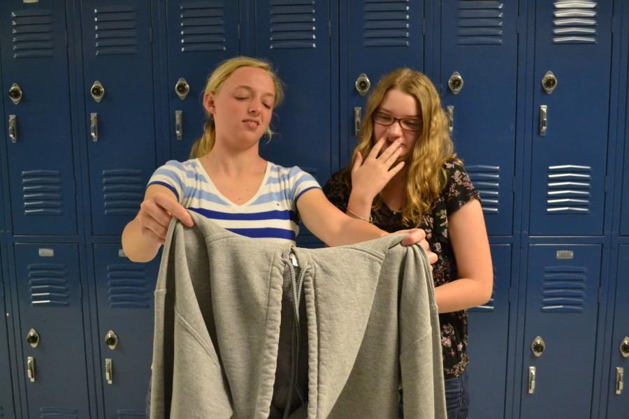 Repulsed by Urban Outfitters product choices, junior Emmy Thompson and senior Sarah Mockalis are, scoff an offensive sweatshirt. “Clothing like this is why I don’t shop at Urban Outfitters.” remarked Mockalis. 
