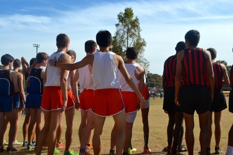 The Varsity boys team wishes each other luck at the start line, preparing themselves for the upcoming race. The team includes juniors Stephan Gardener and Caleb Griffen, and Seniors Nick Nasr, Jordan Wehner, Josh Wehner, Adam Costello, and Ricky Ozawa. 