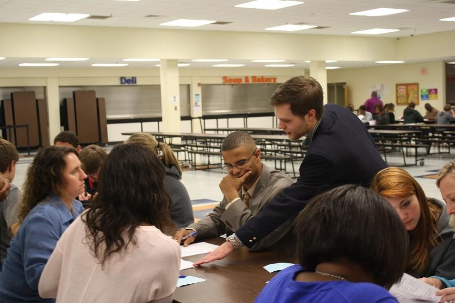 The admissions officer from Emory helps out a NC parent as he goes over the student application. 
