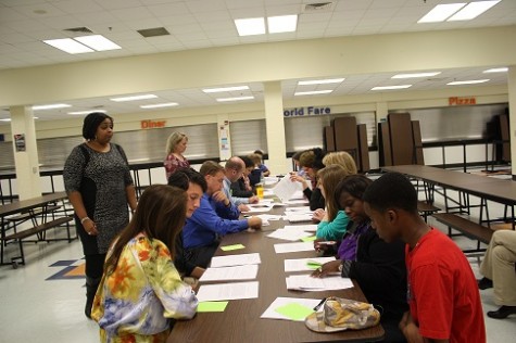 The large group was split into sections, and each section reviewed a separate student application. The invited admissions officer presided over specific tables, answering questions and helping people when necessary. 