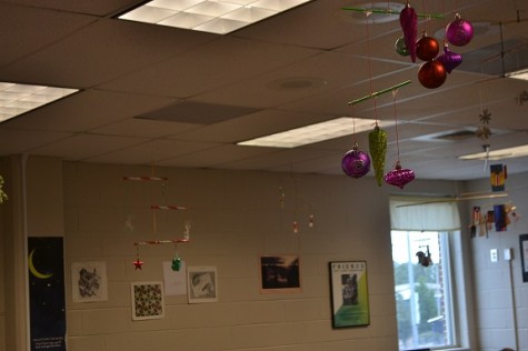 Ms. Ryan’s AP Physics classes gets ready for the up-and-coming holidays by using ornaments and candies to decorate one of their final assignments. The students tied them on a variety of colorful sticks using green and red pieces of yarn, balancing all the components of the project. Ms. Ryan hung them up in her classroom over the weekend to liven up the room and hopefully spread some holiday cheer to her other students.
