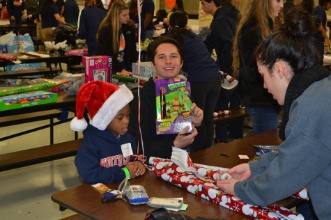 Shop With a Warrior volunteers helped students wrap their gifts for their families to have a true Christmas surprise when they got to open them.