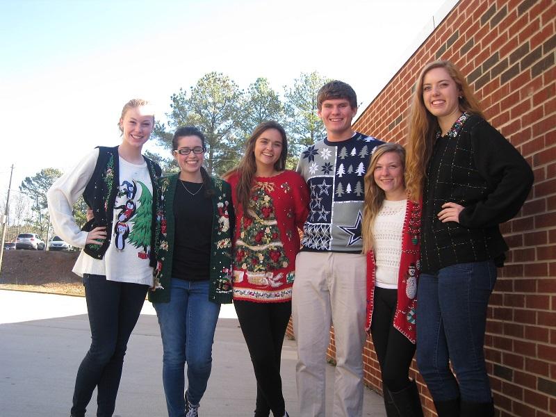 Seniors Caleb Bacak, Savanna Gonzales, Melissa Kelsey, Victoria Wright, Lucy Clay, and Catherine Lamb gather around wearing their christmas sweaters for Tacky Sweater Day. Gonzales said cheerfully, “Tis the season to be tacky.”
