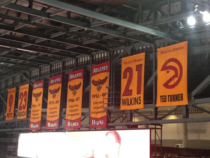 The banners hanging in Philips Arena which includes the retired number 21,9, and 23 from Dominique Wilkins, Bob Pettit, and Loud Hudson. It also includes previous team owner and Atlanta icon Ted Turner, and multiple division titles.  
