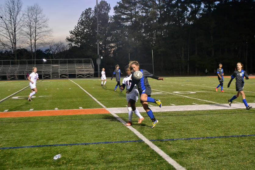 Freshman Zorae Tomlin chases the ball as a Lady Cougar kicks it away. Tomlin finished the game with two goals.