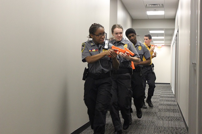 Team leader senior Tanisha Plarchie, leads the group in clearing the room, while Kennesaw State students Allison Owens and Vaughn Benard, and senior Zach Wagoner follows in sync.
