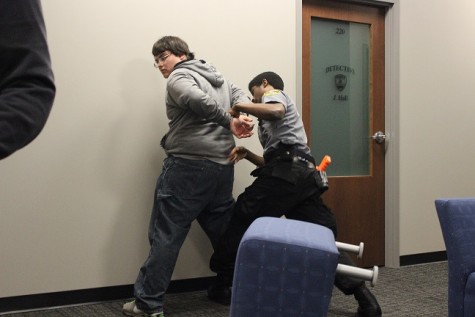 In a officer down scenario, KSU student Vaughn Bernard pats down junior Austin Ingraham, who was the assailant in the situation. “I think our most powerful weapon is our confidence in what we learned, which will help us beat other teams in the biggest competition of the year,” said Bernard. 