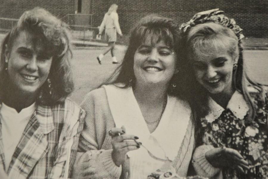 	North Cobb’s 1991 yearbook staff captures a candid moment between three girls enjoying their lunch outside of the school building.