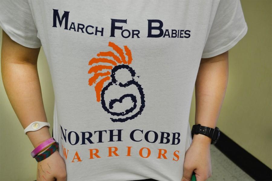 Due to the cancellation of their Saturday event, March of Dimes volunteers wear their shirts today in advocacy of the cause. “I’m really happy that even though we didn’t get to march for them, we still get to support them in some way” said junior Kiky Etika.