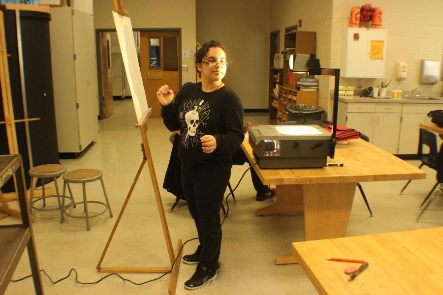 Senior Ana Rivadereyra creating an art piece inspired by one of her favorite fairy tales, the story Snow White.  