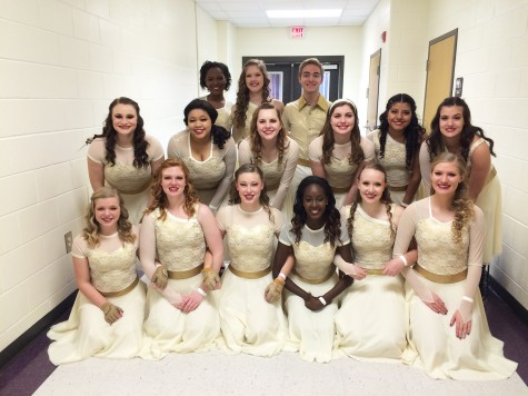 Before performing at their Kell competition, the winter guard poses for a picture. “I will miss the guard so much next year. I do not know what I will do without them,” said Lucy Clay. 