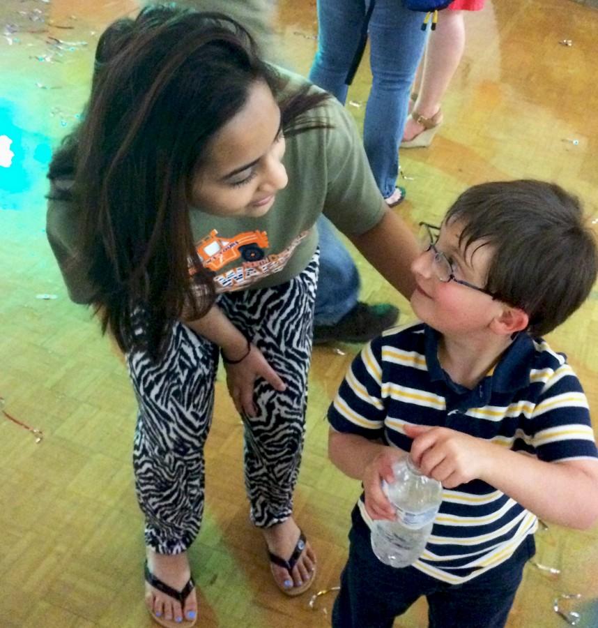Junior Nabila Pranto volunteered at the Special Needs Dance held this morning in the gym, she asks one of the children whether they would like to dance with her or not. “Yes, I want to!” exclaims the child.