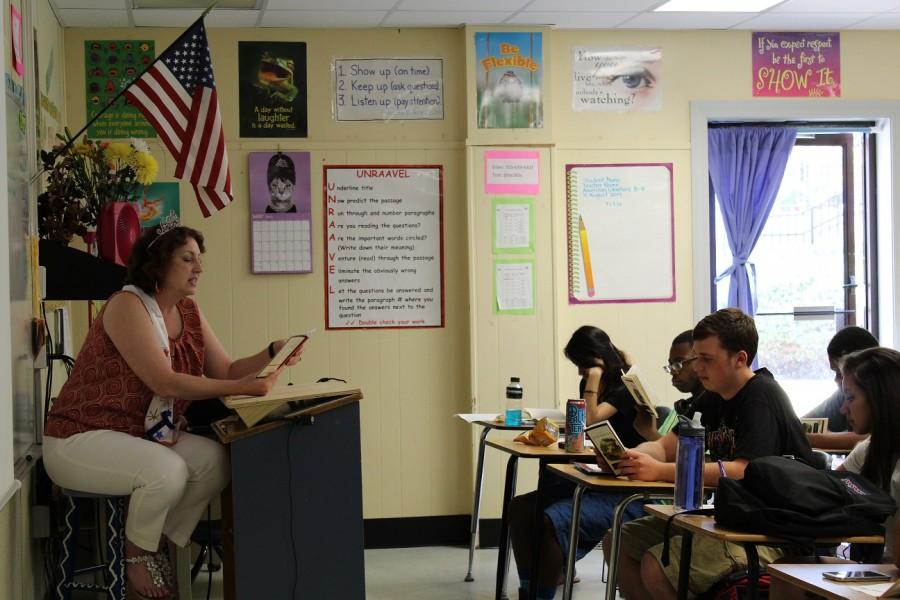 The recently awarded 2015-2016 Teacher of the Year, Special Education educator Christina Mayes, reads Of Mice and Men to Ms. Jackson’s third period class, decked in a sash and a tiara to celebrate the honor.