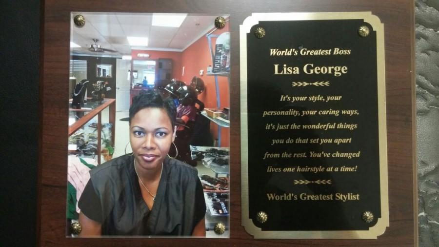 After many years of service and exquisite hair styling techniques, Lisa was awarded World’s Greatest Boss and  World’s Greatest Stylist by Darline DAmour, which hangs right behind Lisa’s station. D’Amour commented, “she deserved to be recognized for her hard work, skills, immaculate taste, and big heart.”