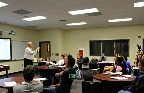 Board Chair Randy Scamihorn lofts up one of the many nonfiction books he presented to the class, explaining the leadership qualities of prominent world figures, as well as important qualities to carry in the life of a leader. “Everyone of those books are about how different people succeeded, who they learned from; all of them espouse sound management and leadership qualities, and it’s a way I can present the material to try and keep the class involved as best I can,” he said. 