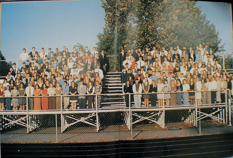 Senior+class+of+1994+poses+for+their+class+picture+on+the+bleachers+by+the+football+field.%0A
