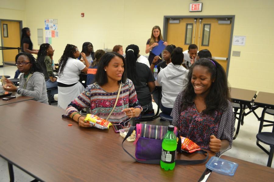 
Freshmen Nefertiti Shabazz and Mackenzie Thomas laugh together during lunch, at ease and unconcerned on their third day of school.
