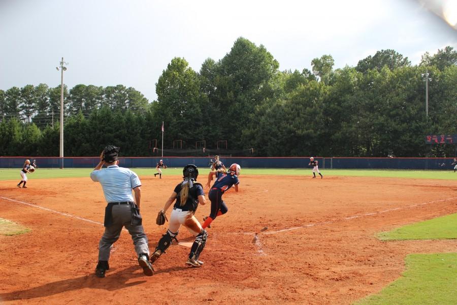JV softball player Olivia Gomes (#7) runs to first after hitting a single.