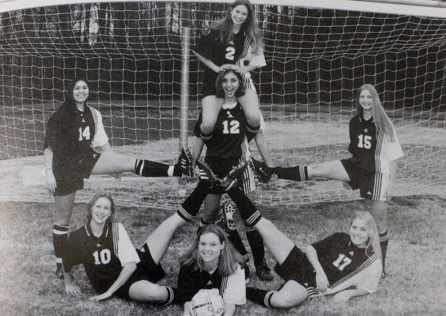 The 1998 NC girls soccer team poses on the field in front of the goal for a wacky team photo that will be put in the yearbook.