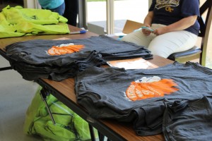NC Cross Country hands out shirts for those who signed up for the annual Warrior War 5K, taking place tomorrow, September 19. “Warrior Way is our only fundraiser of the year and we hope to provide a great experience for all of our racers, we have about 350 signed up and we’re going to use the NC trail, so its fun to have it on campus and see the community and have family members and friends of our athletes come out to support them at what they do best,” said Cross Country coach Sarah Bowling. People wishing to participate in the race, but not yet signed up, can still sign up tomorrow by paying the 25 dollars in cash.
