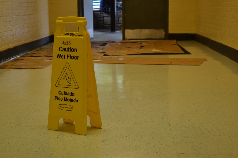 After a massive downpour of unexpected rain, NC janitors rush to eliminate any incoming water. Several disassembled boxes were scattered near the entrance of the 200 hall today. They hope to use the slabs of cardboard to absorb the rain and prevent any slips and falls.