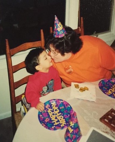 Brown’s mom gives him a kiss at his birthday party, showcasing her unconditional love that exists throughout his adolescence.