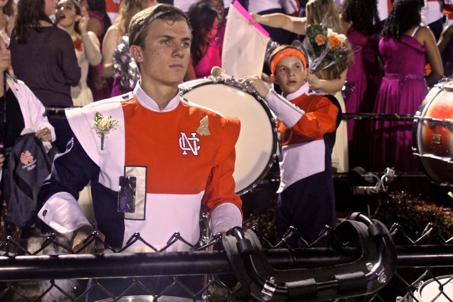  Joseph Loch stays focused as he plays stand tunes on his center snare despite a roaring crowd surrounding him. It was an emotional night for Loch as it was his final senior night but he enjoyed every moment of it. 