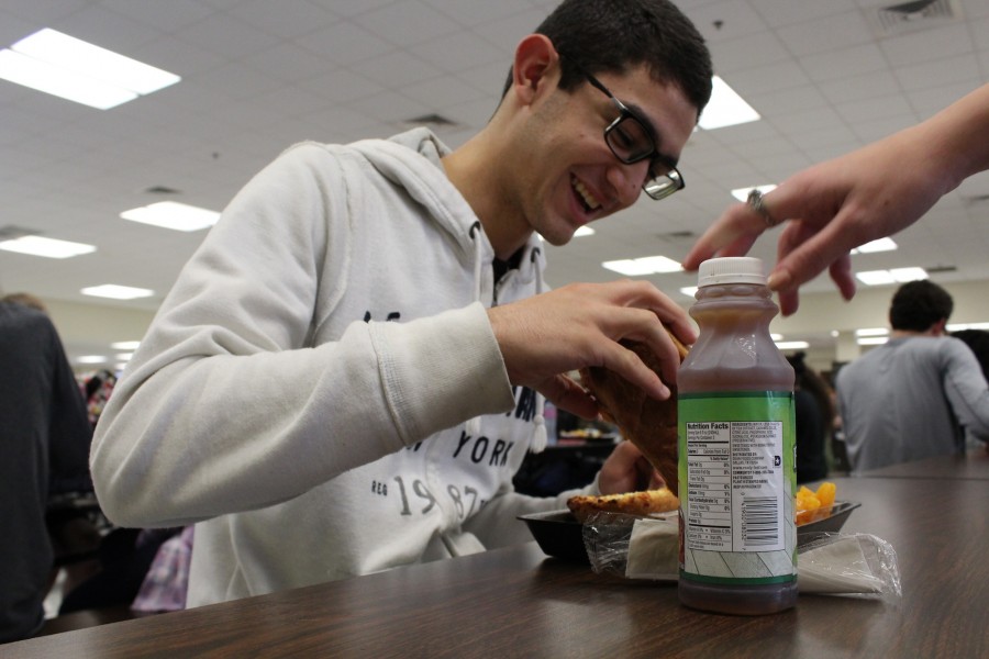 Ricky Medina smiles as he enjoys his school lunch with friends. Medina commented, “I buy school lunch every day and I’m quite happy with the amount I get.”