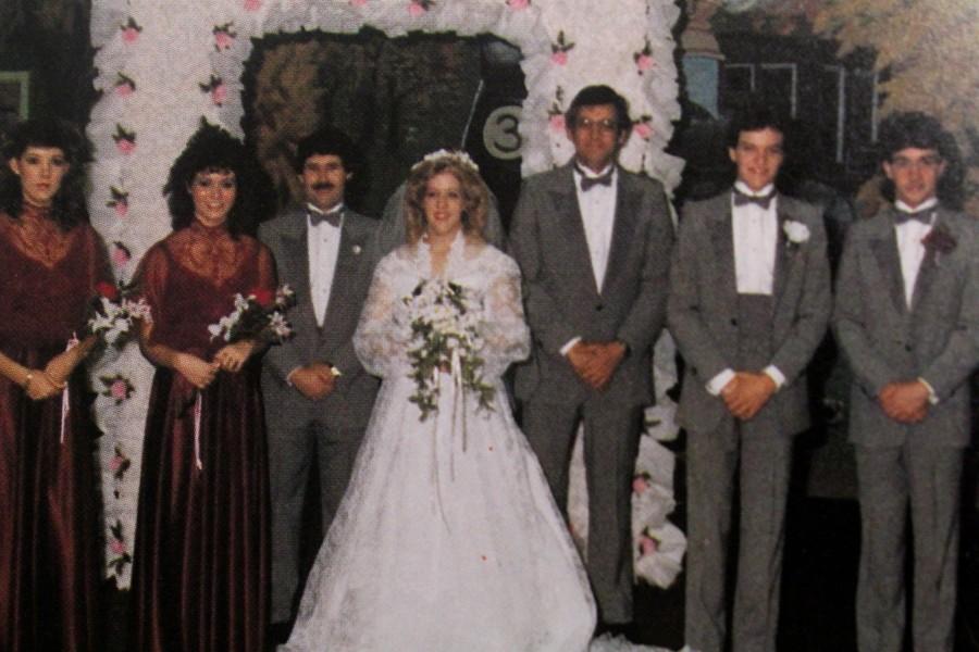 Students in a 1986 NC yearbook pose during a mock wedding set up by the school. The event allowed girls to go through the planning process of a real wedding to prepare them for the real thing.