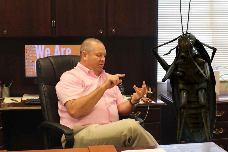  Principal Bucky Horton negotiating with the leader of the cockroach clan, Cucaracha Marrón. “Reaching an agreement that works for everyone was the most important part of the meeting,” said Marrón. The population, as most students can clearly see, dwells in the gym area and the 600 halls.
