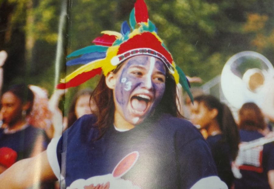 A student displays her avid school spirit at a football game in the spirit section of a 2003 edition of NC’s yearbook.