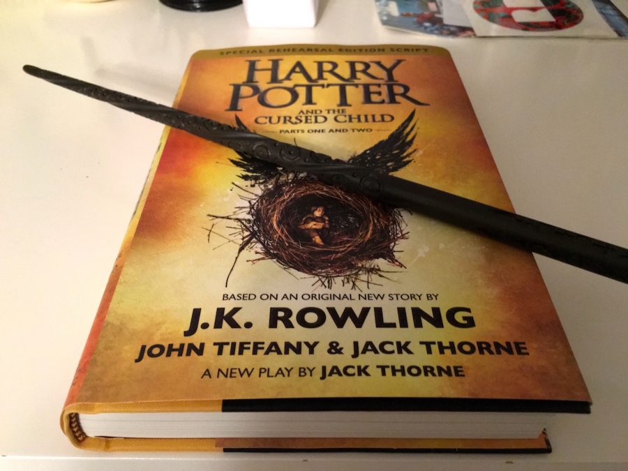 A student shows off the play Harry Potter and the Cursed Child, as well as a replica wand from the movie. The new piece, based on an original story by J.K. Rowling and written by Jack Thorne and John Tiffany, hit bookstores on July 31, 2016.