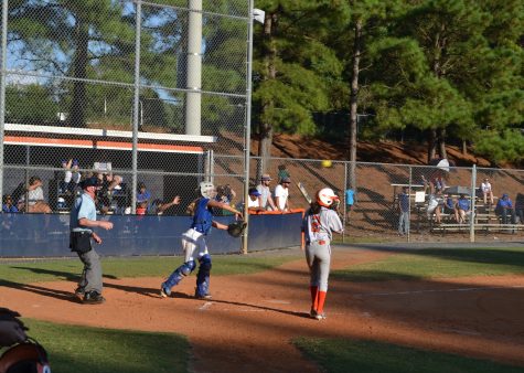 The umpire tosses back the ball as Sophomore Angela Cecere prepares to hit again. Cecere’s hit contributed to NC’s stunning 13-1 victory. 
