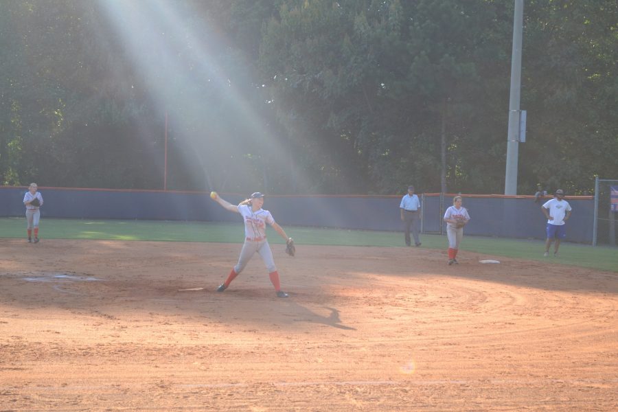 A beam of light shines on senior Julie Sanderlin as she pitches. Only divine intervention can explain NCs victory.
