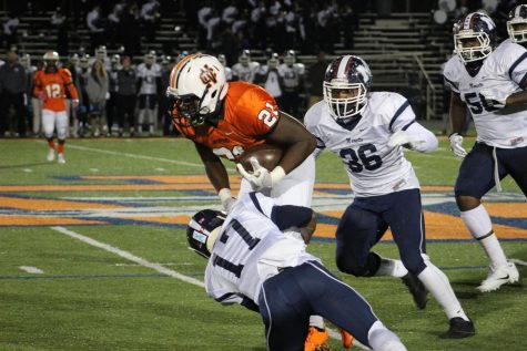 #21 CJ Cole fights for extra yards as he pushes for a first down against the Blue Devil defense. 