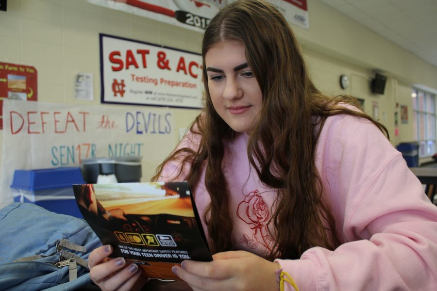 Senior Kelsey Bacak reads over a brochure listing tips for teen drivers. Representatives of the CDC and Department of Health & Services visited NC to spread awareness about safe driving.