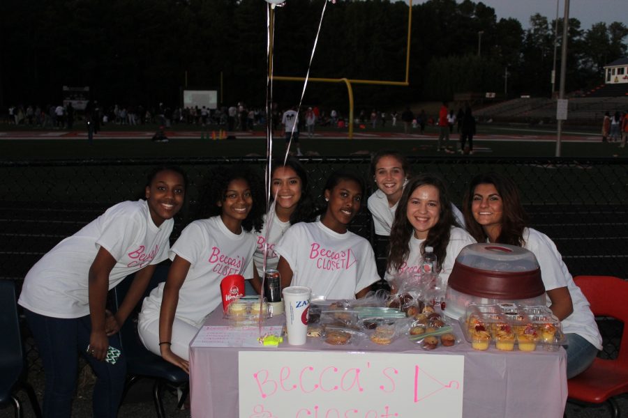 Patricia Collins, Sydney Sims, Stefanie Garcia, Kaylee Hulston, Bailiegh Krause, Rylie Geraci, and Najda Sahovic pose for a picture as they sell baked goods for Becca’s Closet. 