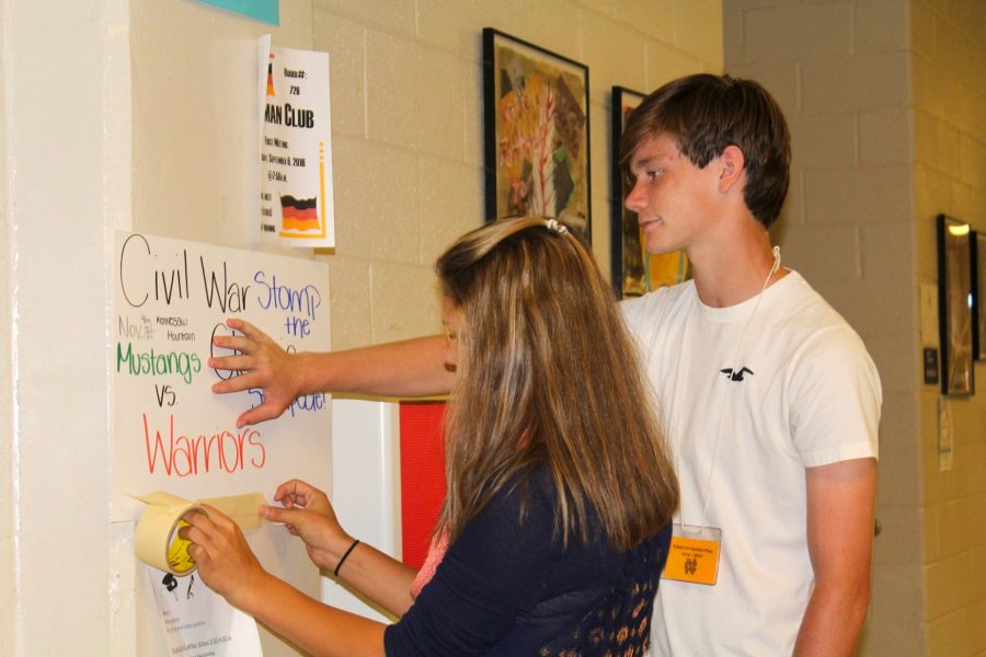 Freshmen Malina Cagle and Brian Morgan are hanging up posters promoting today’s Civil War game against the Kennesaw Mountain Mustangs. The Warriors plan to continue their dominance against their in-town rival as they look for their eighth consecutive win. The game will be played at Kennesaw Mountain, so make sure to go out and support the Warriors!