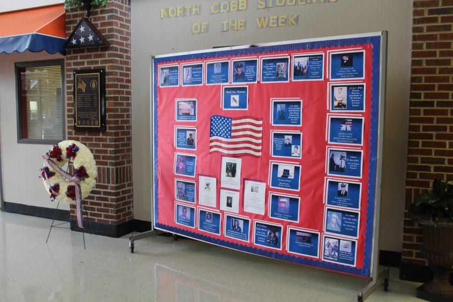 A Veteran’s Day billboard with pictures of staff members, as well as their family members  stands in the front of the school to commemorate their service to the country. In addition to the billboard, a cermony honoring veteran’s took place in the auditorium during first block. “It was interesting and inspiring, and it showed me how much hardship the people had to go through to keep our freedoms.” Sophomore Cedric Pfeiler said.  
