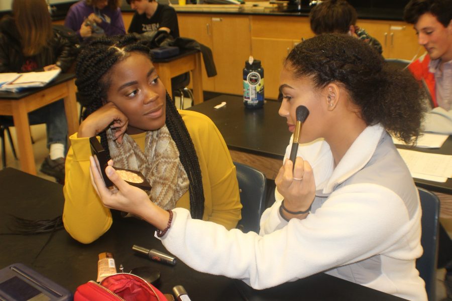 Seniors Kamree Moore and Cameron Davenport discussing and applying makeup during class. “I love Maybelline Fit Me, but at the same time I notice how limited the shades are,” Moore said. “I know it wasn’t made for girls darker than me.”