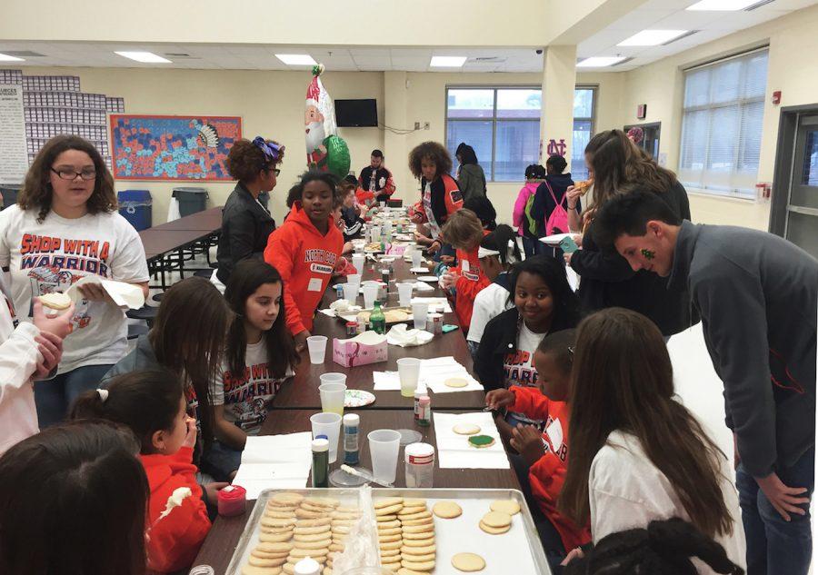In the freshman cafeteria, little warriors decorate their own sugar cookies with Christmas colored icing and sprinkles.