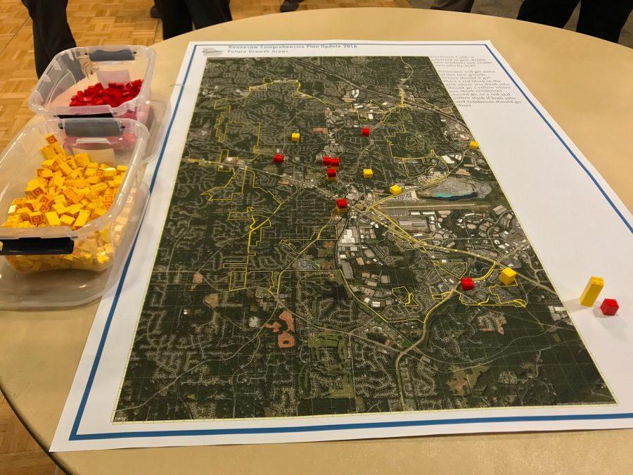 The open house asks visitors to place legos on a map of Kennesaw where they would like to see more residential (yellow) and business (red) development.